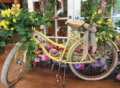 A bicycle decorated with fresh yellow flowers; an accent at our Mobile, Alabama location